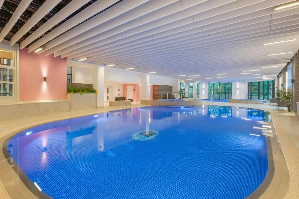 a large swimming pool in a building with a large pool at The Lodges at Craigendarroch Country Club in Ballater