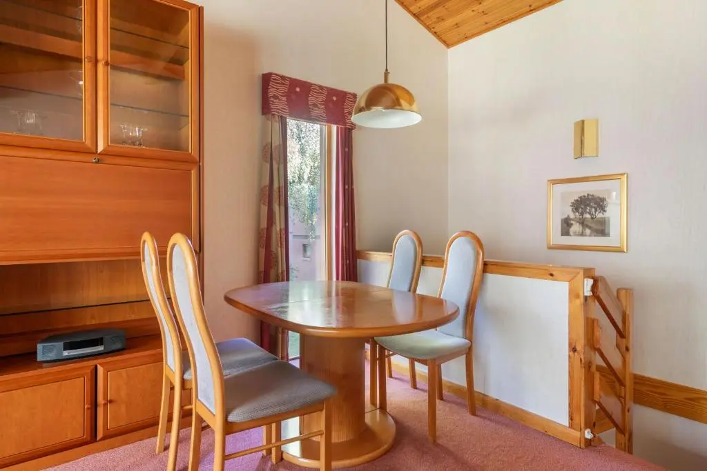 a dining room with a wooden table and chairs at The Lodges at Craigendarroch Country Club in Ballater