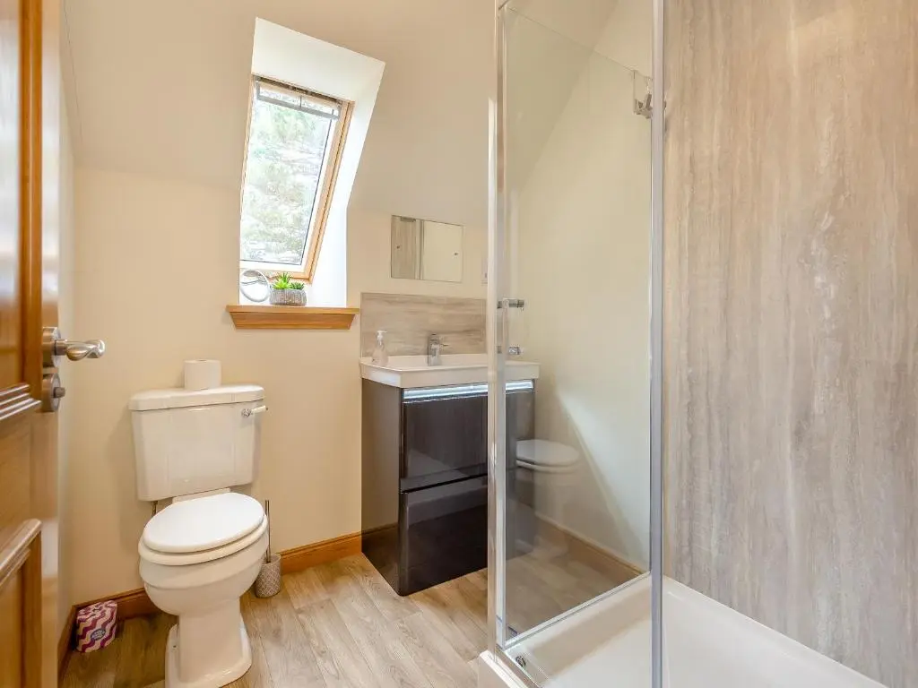 a bathroom with a toilet and a sink and a shower at The Larches - Uk46804 in Culbokie