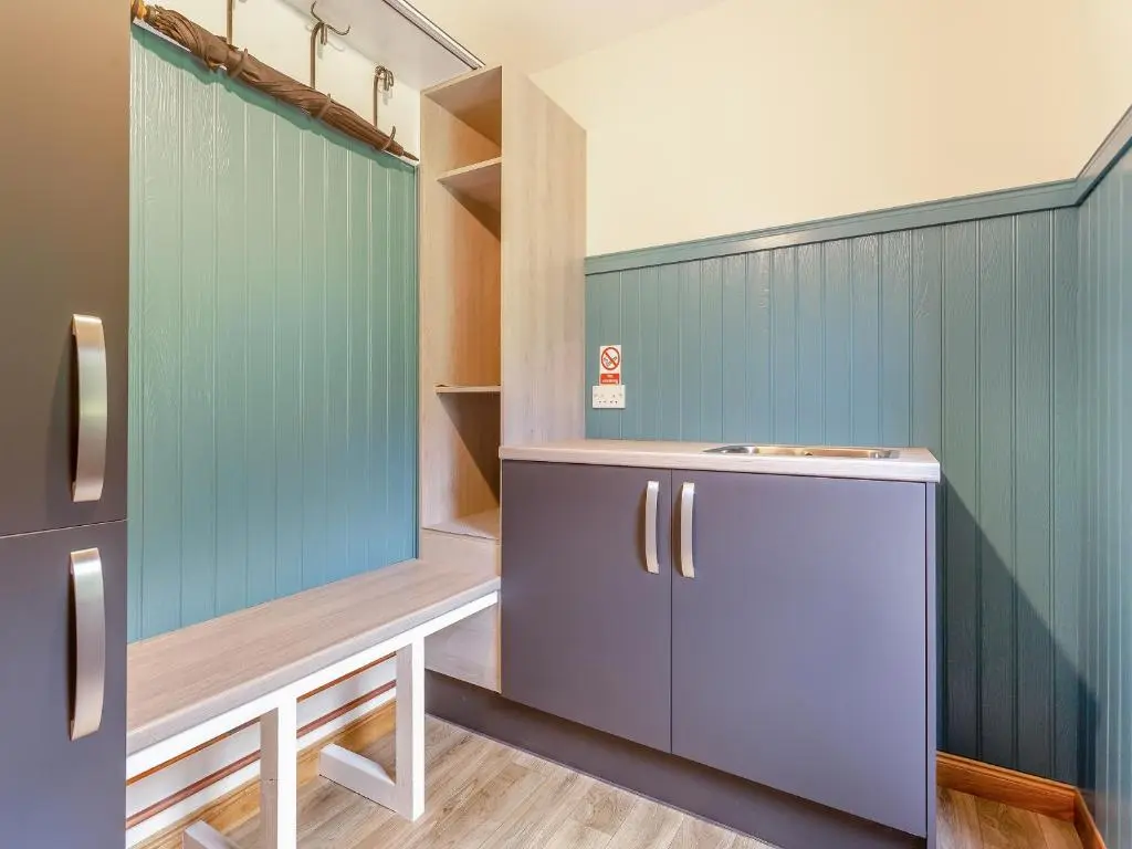 a kitchen with blue walls and a refrigerator at The Larches - Uk46804 in Culbokie