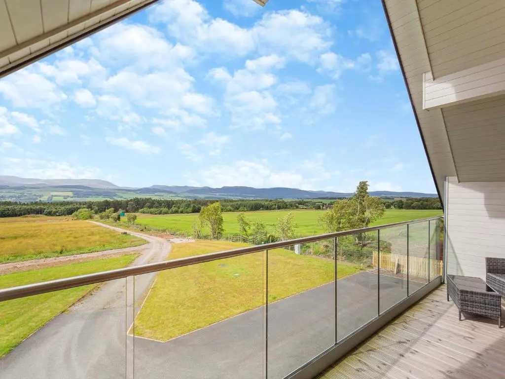 a balcony with a view of a field at The Larches - Uk46804 in Culbokie