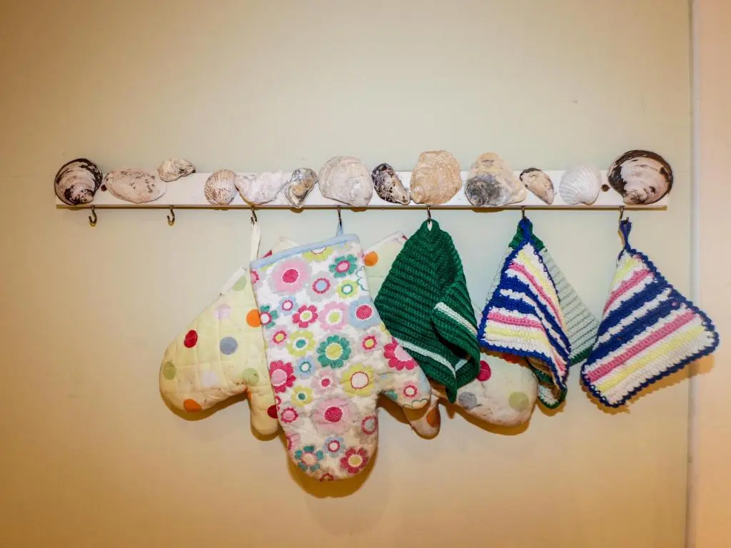 a rack with knitted ornaments on a wall at Seashell Cottage in Cromarty
