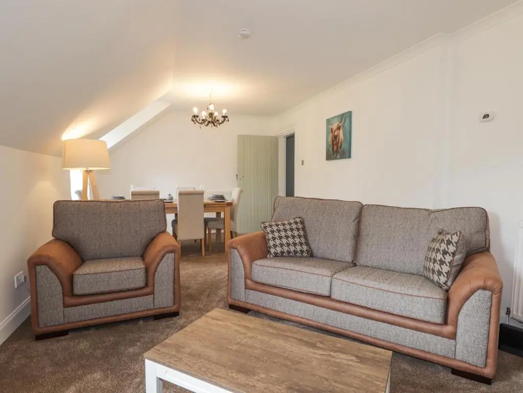 a living room with two couches and a dining room at Apartment in Foyers in Inverness