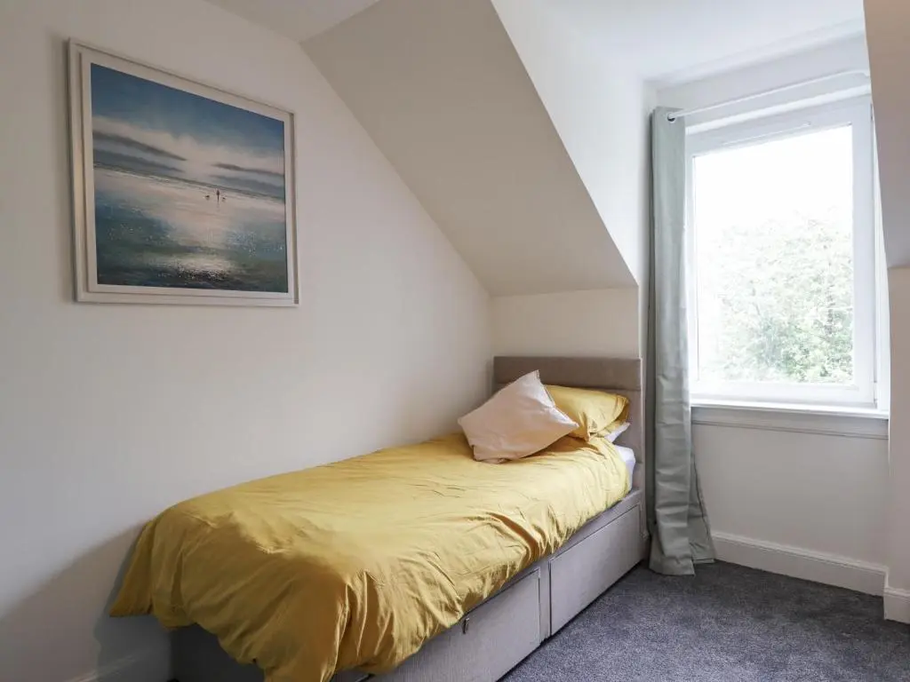 a bed in a room with a window at Apartment in Foyers in Inverness