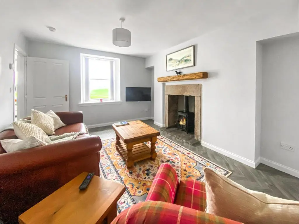 a living room with a couch and a fireplace at Guise Cottage Uk46303 in Tough