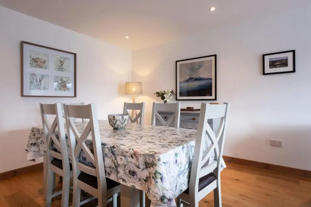 a dining room with a table and four chairs at The Steadings in Aviemore