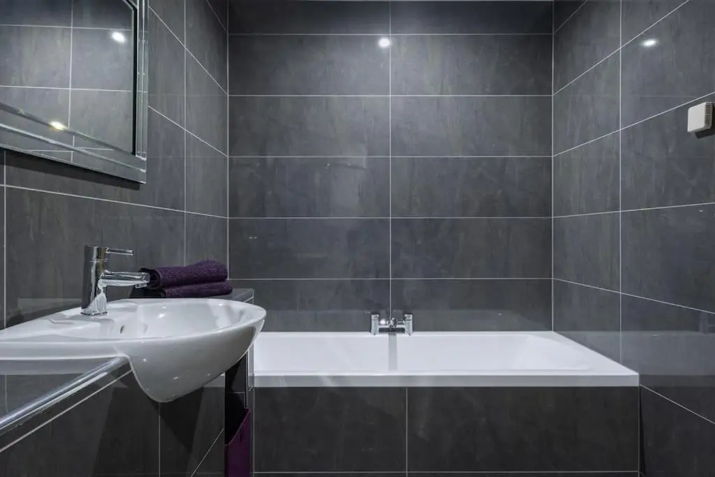 a bathroom with a sink and a bath tub at The Steadings in Aviemore