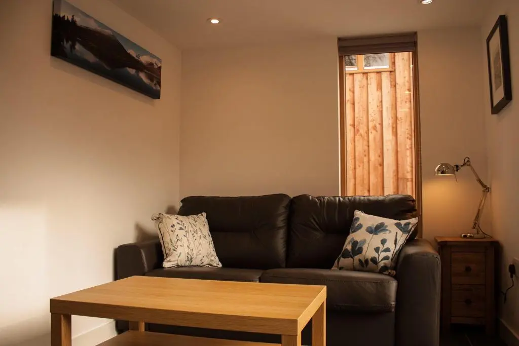 a living room with a couch and a table at Callater in Braemar