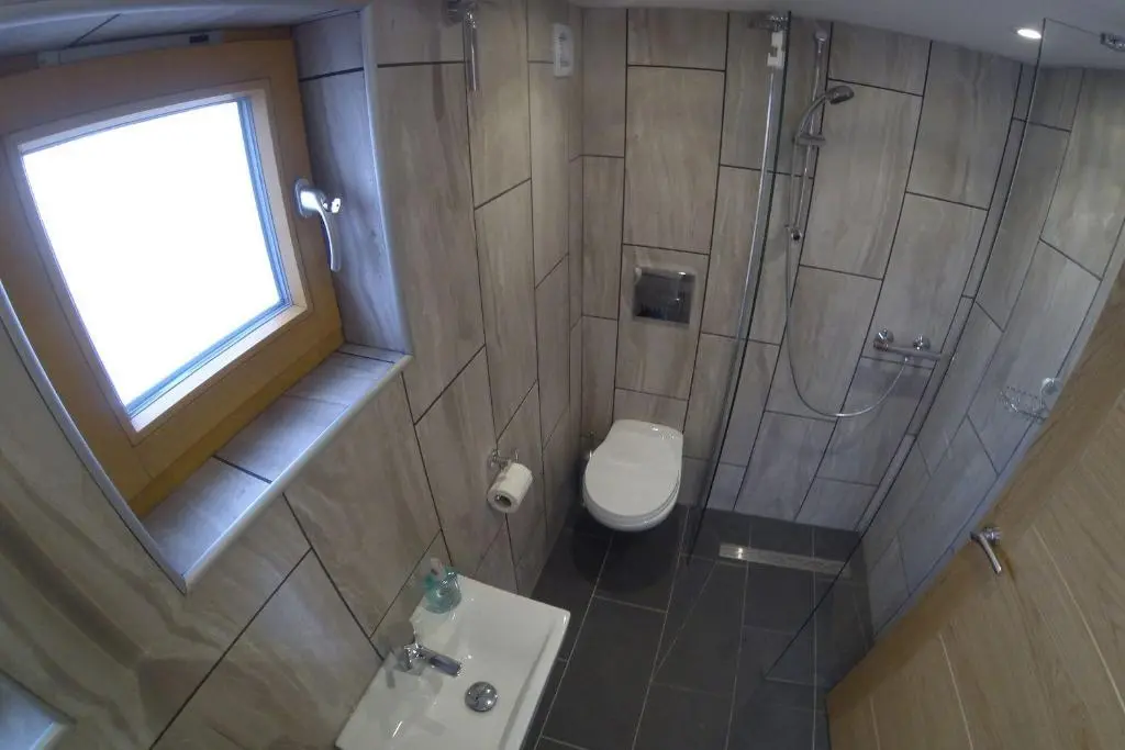 a bathroom with a shower and a toilet and a sink at Callater in Braemar