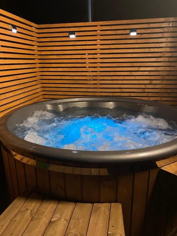 a large hot tub with blue water in it at Langdale Lodge in Inverness