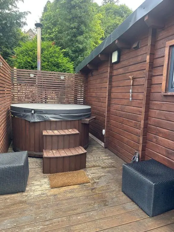 a jacuzzi tub sitting on a wooden deck at Langdale Lodge in Inverness