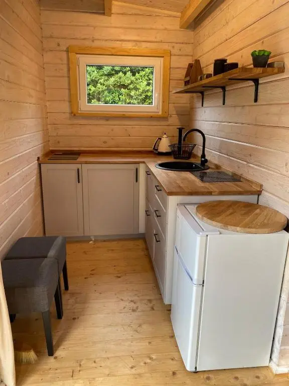 a kitchen in a tiny house with a sink and a window at Langdale Lodge in Inverness