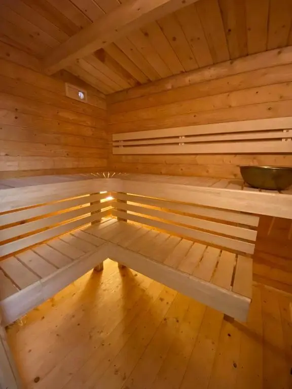a large wooden sauna with a bench in it at Langdale Lodge in Inverness
