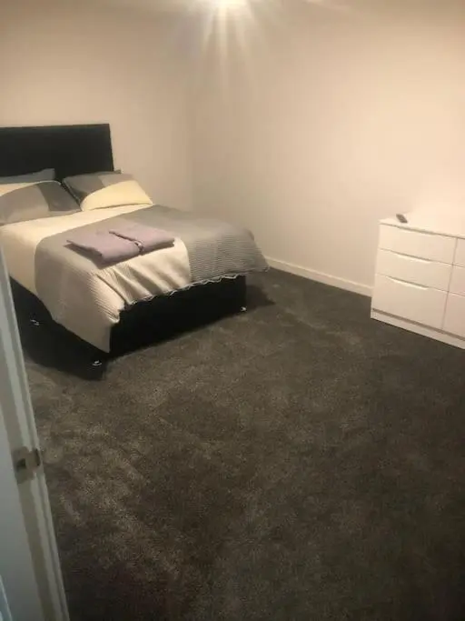 a bedroom with a bed and a dresser at Lisbon 67 in Wick