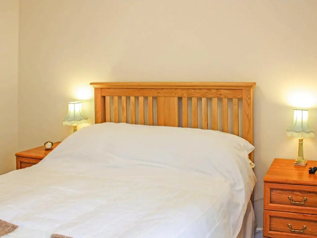 a bedroom with a white bed with two night stands at Apartment 8 The Granary-Uk7466 in Banff