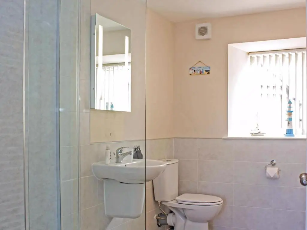 a bathroom with a sink and a toilet and a mirror at Apartment 8 The Granary-Uk7466 in Banff