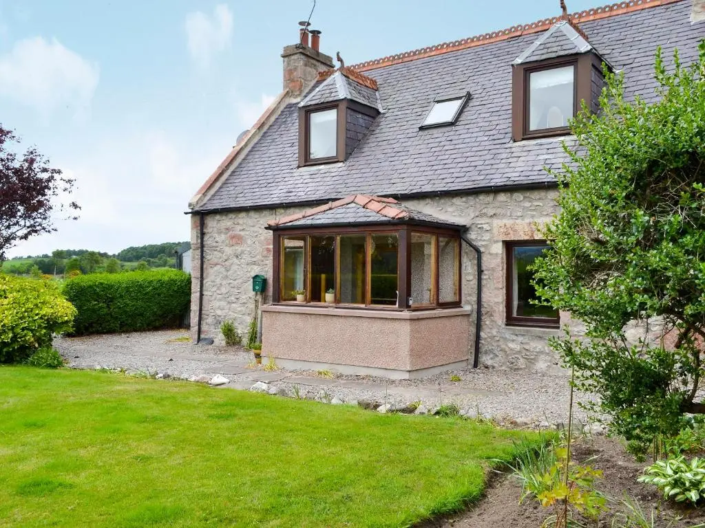 an external view of a house with a garden at Old Post Office House in Knockbain