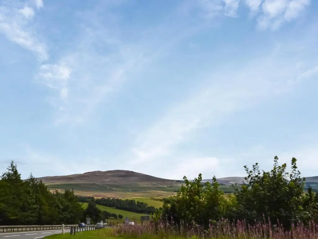 a view of the hills from a road at Douneside Cottage in Inverness