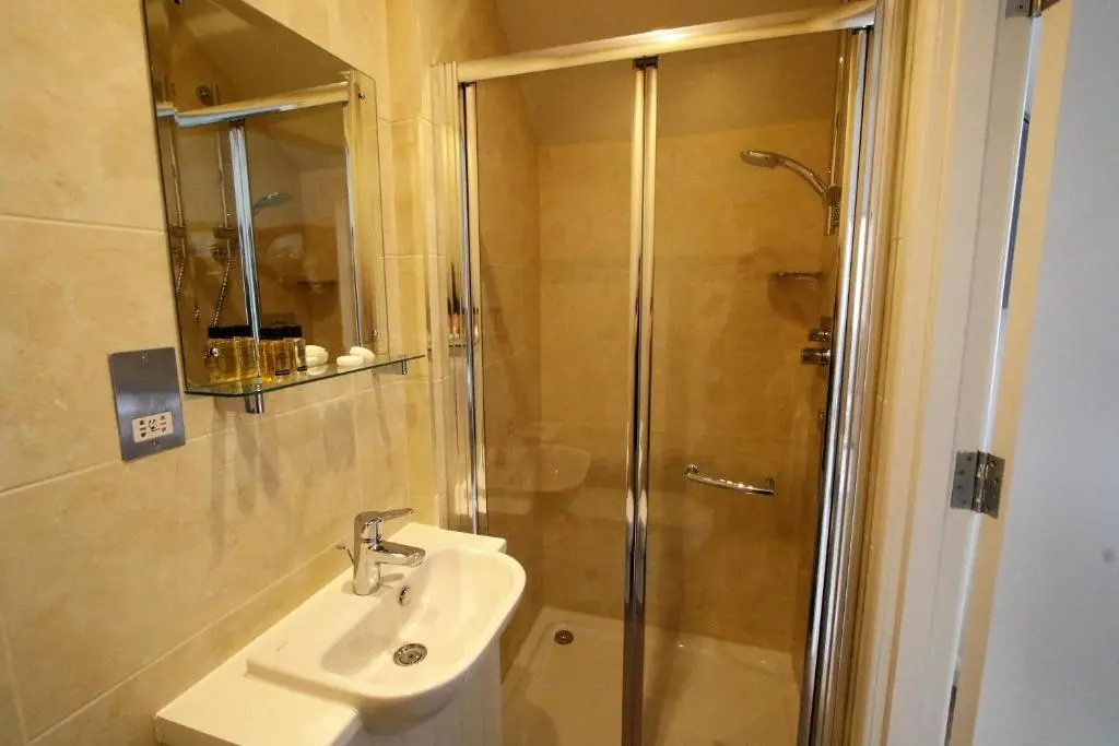 a bathroom with a shower and a sink at Corriegarth Hotel in Inverness
