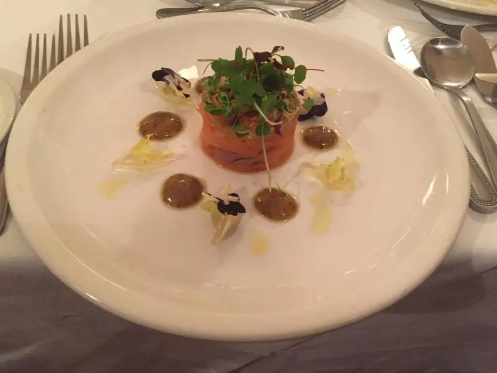 a white plate with a dessert on a table at Nethybridge Hotel in Nethy Bridge