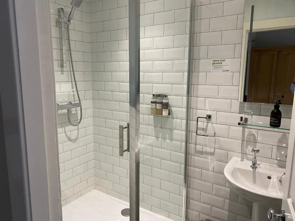 a bathroom with a shower and a sink at Boat Country Inn and Restaurant in Boat of Garten