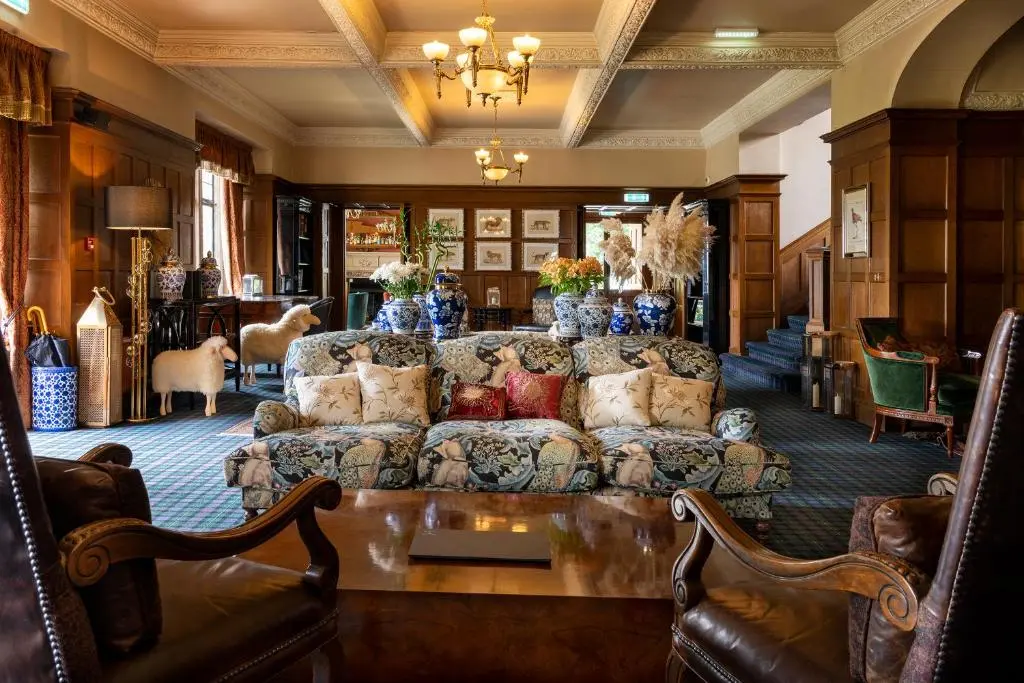 a living room with a couch and a table at Kincraig Castle Hotel in Invergordon