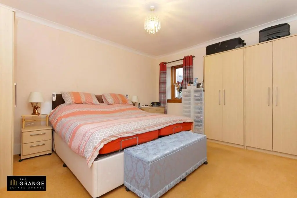 a bedroom with a bed and a dresser and a bed sidx sidx sidx sidx at 2 Bed Cottage Sleeps 4-Pets Welcome-Private Garden in Buckie