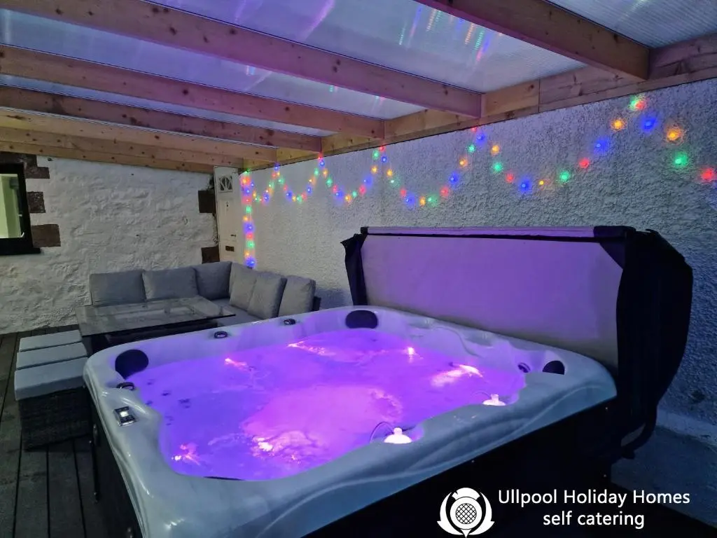 a purple bath tub in a room with a couch at House - Sleeps 8 - Pets Ok - Parking in Ullapool