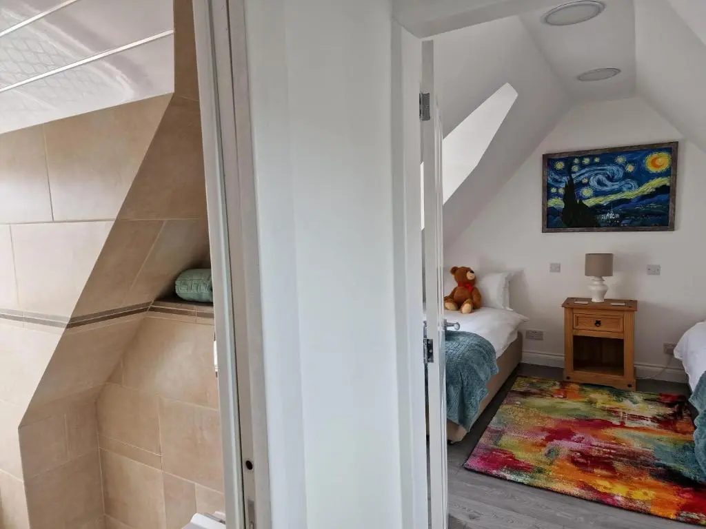 a room with a bed and a room with a doorway at House - Sleeps 8 - Pets Ok - Parking in Ullapool