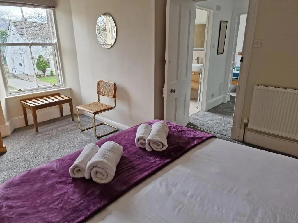 a bedroom with a bed with towels on it at House - Sleeps 8 - Pets Ok - Parking in Ullapool