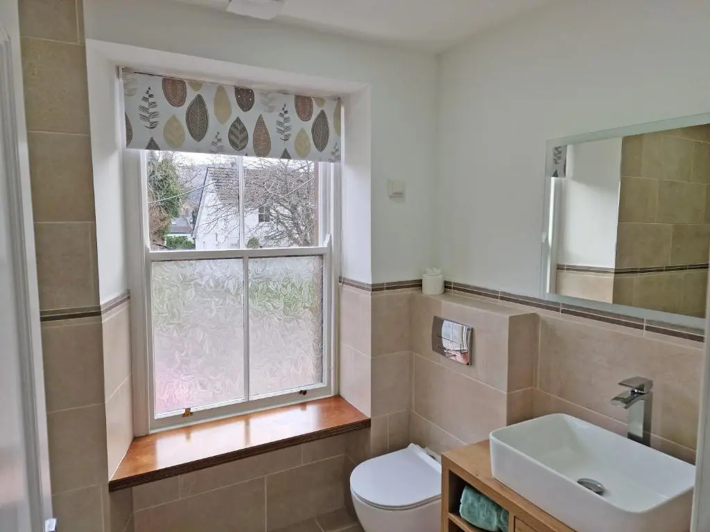 a bathroom with a toilet and a window at House - Sleeps 8 - Pets Ok - Parking in Ullapool