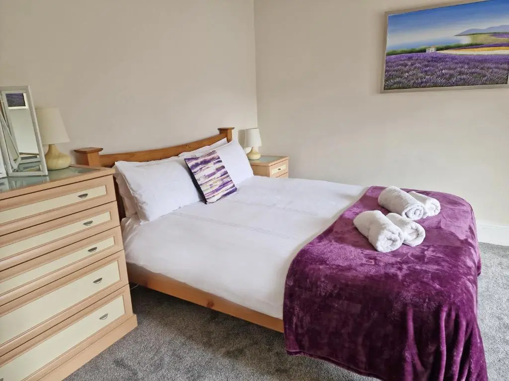a bedroom with a bed with two towels on it at House - Sleeps 8 - Pets Ok - Parking in Ullapool
