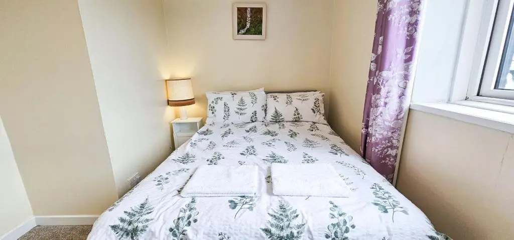 a bed in a small room with a window at 1 Bedroom House - Inverness - River Canal in Inverness