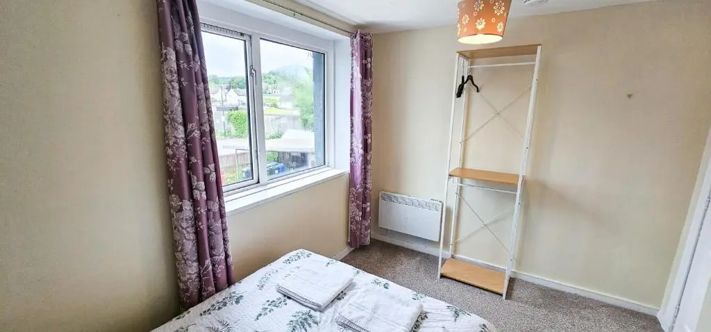 a bedroom with a window and a bed and a mirror at 1 Bedroom House - Inverness - River Canal in Inverness