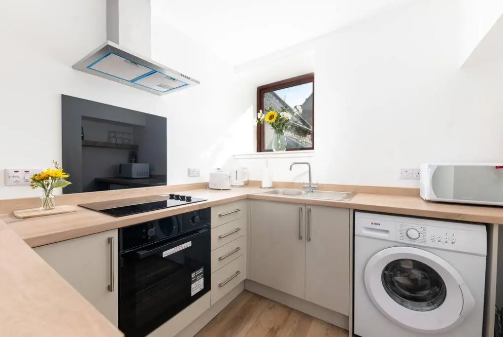 a kitchen with a sink and a dishwasher at Town centre flat in Inverness