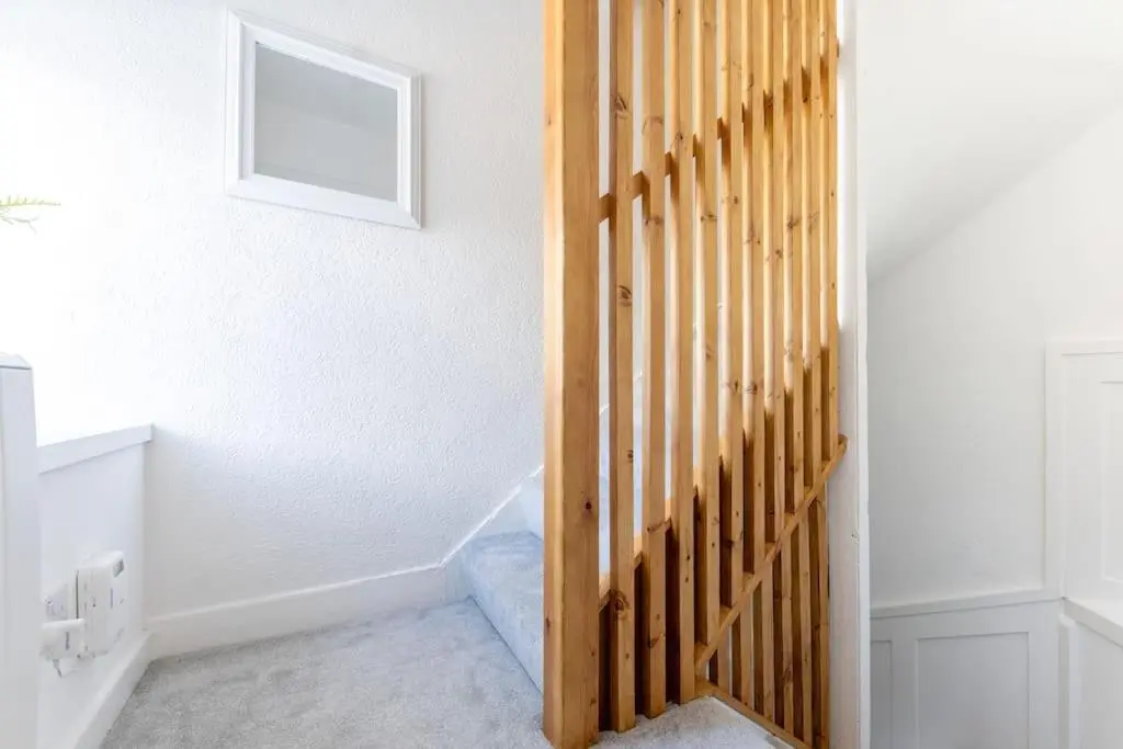 a stairway with a wooden door in a room at Town centre flat in Inverness