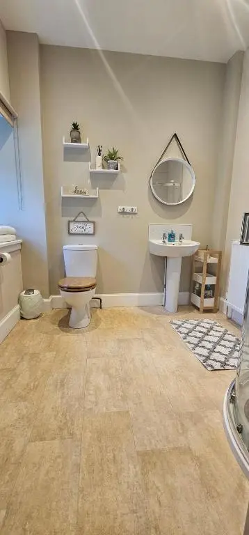 a bathroom with a toilet and a sink at Balmore Farmhouse near Lochness in Inverness