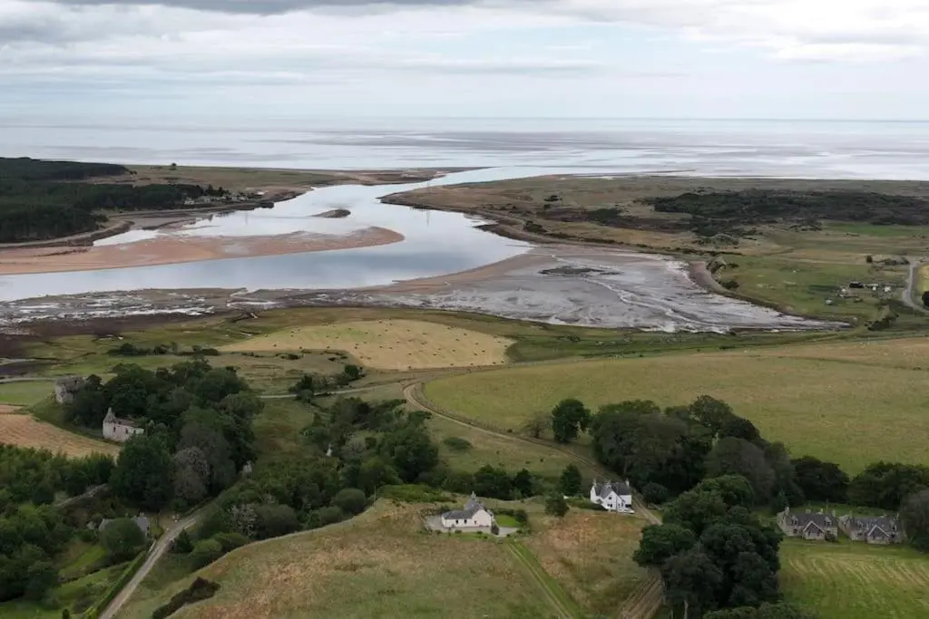 an aerial view of a river and houses on a hill at Grieves Cottage, near Dornoch in Dornoch
