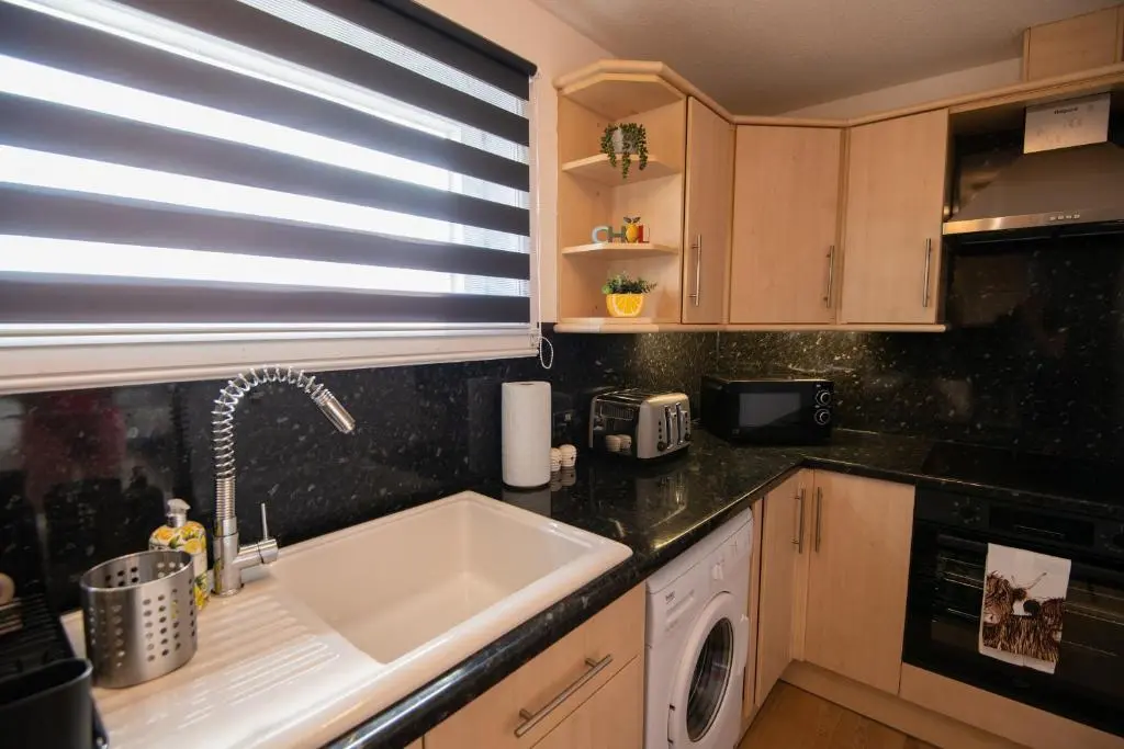 a kitchen with a sink and a window at Two Bedroom Hilton Apartment 1st floor in Inverness