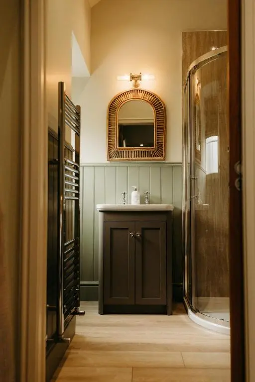 a bathroom with a sink and a mirror at No1 Burgie Mains Cottage in Forres