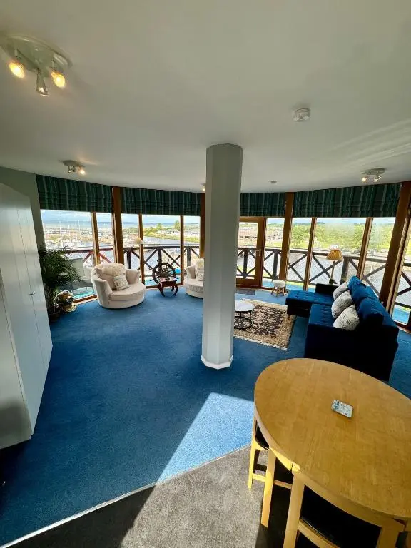 a living room with a table and chairs at The Lighthouse in Nairn