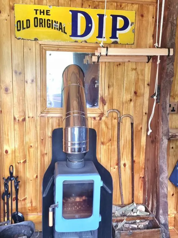 an old original dip stove in a wooden cabin at The Shepherds Neuk in Inverness