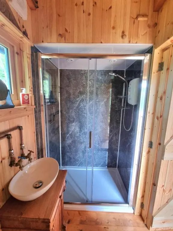 a shower with a glass door in a bathroom at The Shepherds Neuk in Inverness