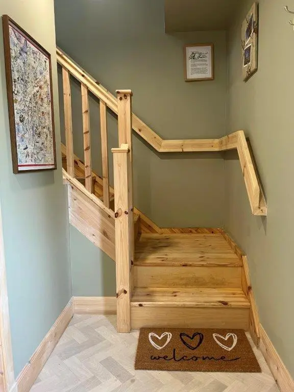 a wooden staircase in a corner of a room at Endeavour Guest House in Aberdeen