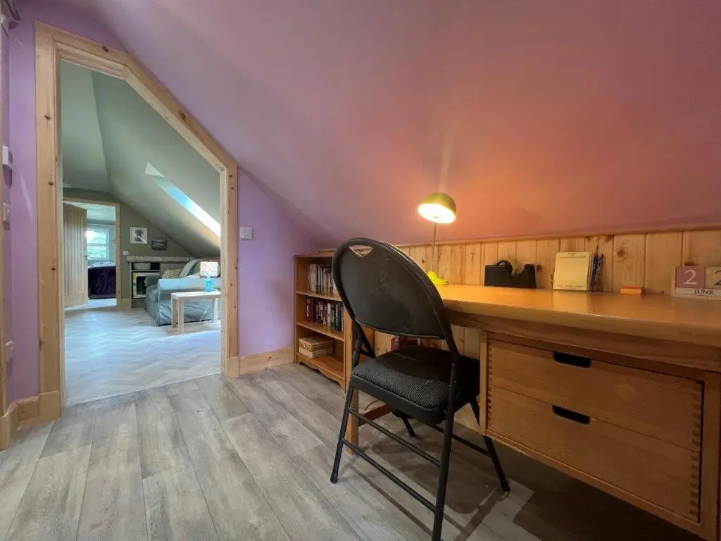 a desk with a chair in a room at Endeavour Guest House in Aberdeen