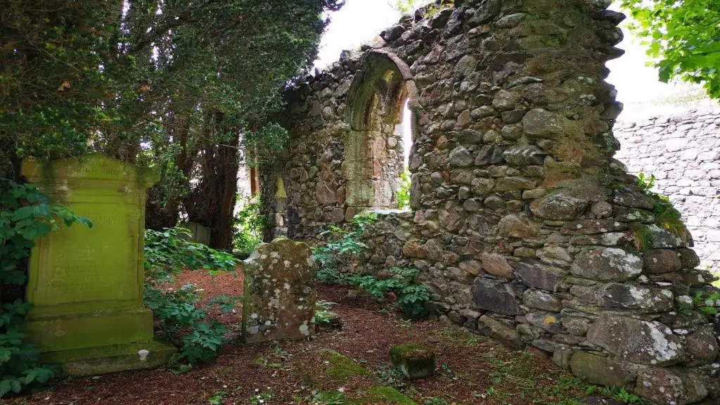 an old stone building with a stone wall at The Wee Heilan' Coo in Nairn