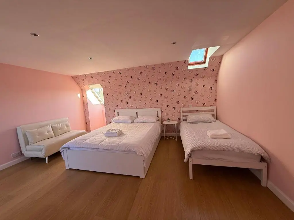 a small bedroom with two beds and a couch at Sunshine three bedrooms Apartment in Insch