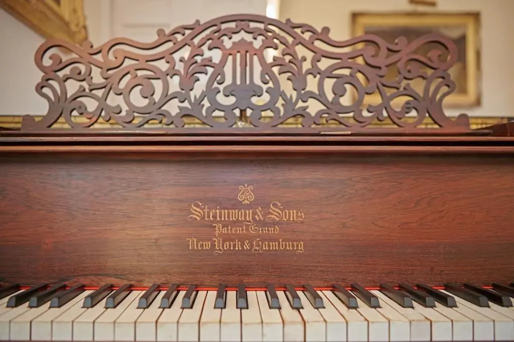a wooden piano with a sign on the top at Idyllic 12 bedroom Country Home in Forres