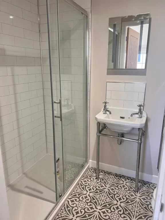 a bathroom with a shower and a sink at Linden Cottage in Fortrose