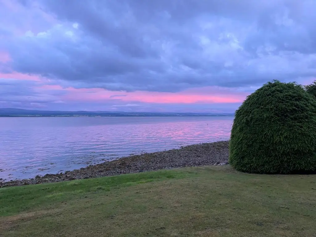 a bush on the shore of a body of water at Linden Cottage in Fortrose